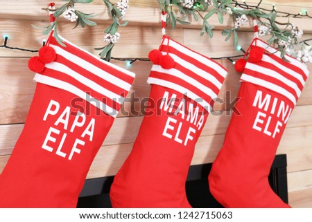 Christmas stockings hanging on wooden wall. Festive interior