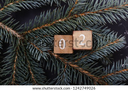 Advent calendar. Countdown to Christmas. Wooden numbers. Number two. Christmas background. Winter background.  Royalty-Free Stock Photo #1242749026