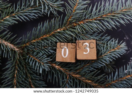 Advent calendar. Countdown to Christmas. Wooden numbers. Number three. Christmas background. Winter background.  Royalty-Free Stock Photo #1242749035