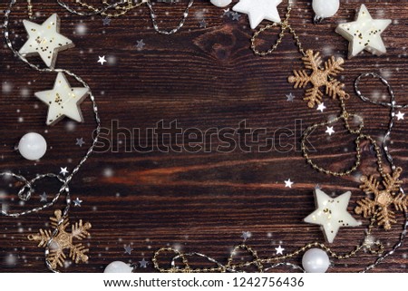 Winter background with frame of holidays decorations with copy space on wooden table. Flat lay.
