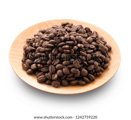 Coffee beans in small wooden dish on white background