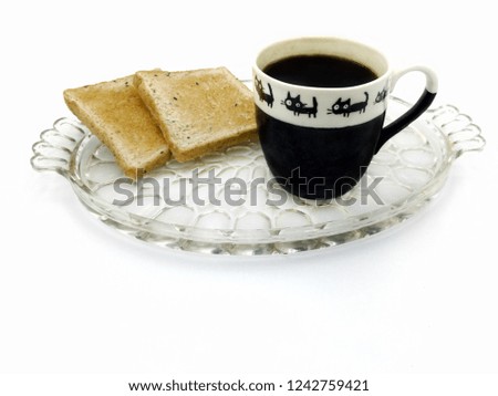 Americano Black Coffee in the black and white cup with black cat cartoon on white background with Toasts for easy breakfast on the glass plate in the white background.