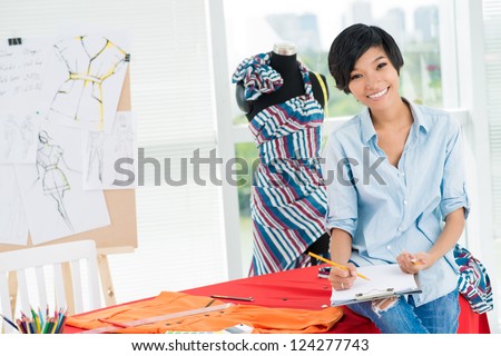 Asian girl sitting on the table and smiling