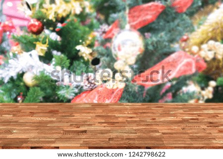 Perspective empty wooden table and christmas tree blur decoration background, for product display montage or design layout.