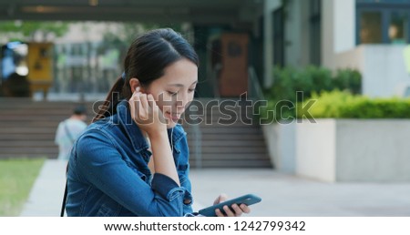 Woman listen to music on mobile phone