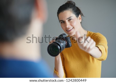 Beautiful professional photographer taking photos of a model                              