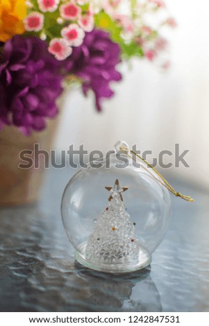 blurred empty glass Christmas ball with a snowflake and gold thread, macro shot