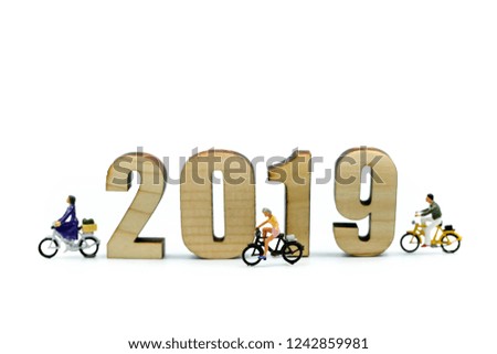 Miniature people : man and friend ride bicycle with wooden number of 2019,Happy New Year 2019 concept.