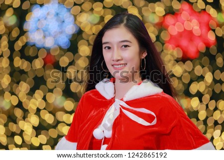 Portrait of beautiful Happy christmas Santa woman asian on New Year and Christmas holiday abstract party bokeh background.