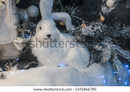 Ornaments christmas tree. gifts under the tree. White rabbit figure