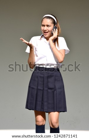 Female Using Cell Phone And Unhappy Wearing Skirt