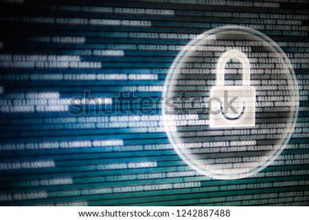 cyber security. white light padlock icon on led computer screen monitor display. blue and green colors with binary code moving motion from left to right.