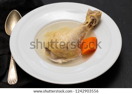 soup with chicken on white plate