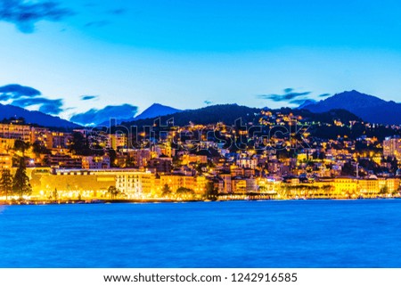 Sunset view of old town of Lugano facing the Lugano lake in Switzerland
