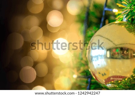 Close up of christmas tree decorated with gold glitter balls and  gold bokeh background with copy space for your text.