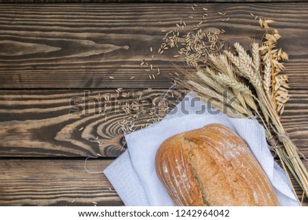 Freshly baked bread products on wooden background