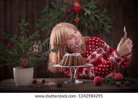 girl making selfie with christmas cake