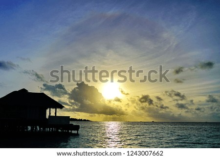 silhouette picture of  water villa in sunset time 