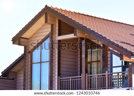 Photo of beautiful modern wooden house and sunshine lights.