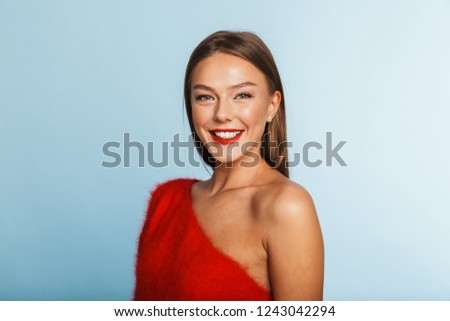 Lovely young woman wearing sweater standing isolated over blue background