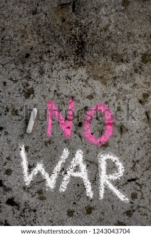 Colorful chalk drawing on asphalt: Words NO WAR