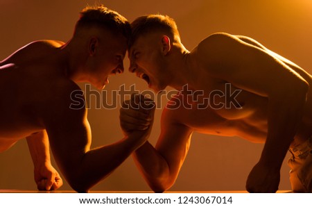 Thats our strength. Twins men competing till victory. Twins competitors arm wrestling. Men competitors try to win victory or revenge. Revenge in sport. Strength skills.