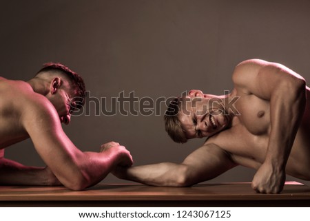 Revenge in sport. Twins competitors arm wrestling. Men competitors try to win victory or revenge. Twins men competing till victory. Strength skills. A strength sport.