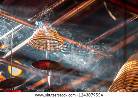 Close up photo of burning spiral candles in Man Mo Temple