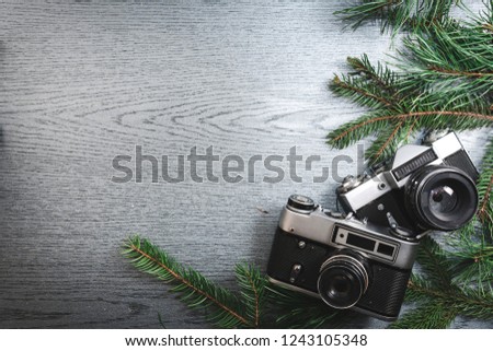 Top View of Vintage Camera Between Christmas tree, on Wooden Texture, copy space