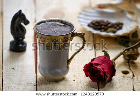 A cup of morning coffee with red flower