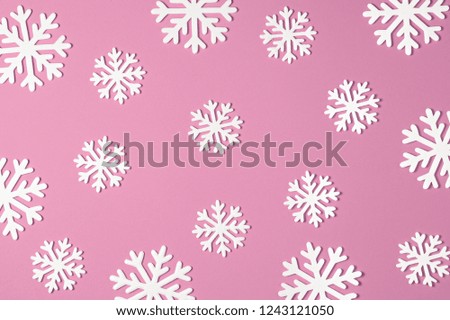 Christmas snowflake on pink background. Xmas minimal texture top view.