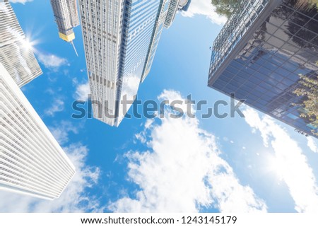 Lookup view of Chicago skylines with working crane on building under construction under cloud blue sky