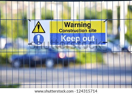Warning, construction site. Keep Out sign on site fence.