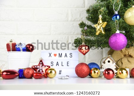 X-MAS SALE text on lightbox composition and Christmas decorations