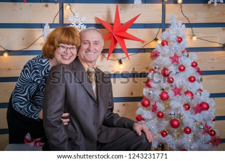 man and woman in christmas. Adult parents Christmas holiday at home. Interior New Year.  Happy mom and dad prepare holiday gifts