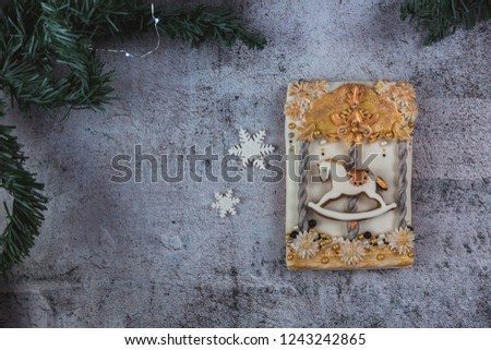 Hand painted Christmas gingerbread horse on a carousel on a beautiful grey background. Card concept. Top view. Flat lay. Copy space.