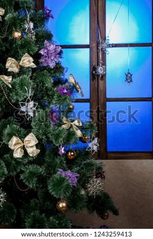 Winter background.Merry Christmas and happy New Year greeting card.Christmas tree with  decorations  and blue light