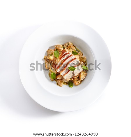 Close-up portrait of cream potato with pork slices. Studio picture of delicious dish served on plate. Restaurant meal concept. Isolated on white background