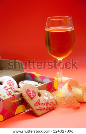 Heart shaped ginger cookies and white wine glass for Valentines Day