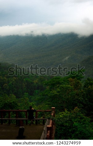 The man sitting and looking morning view at view point of Doi Khun Tan National Park