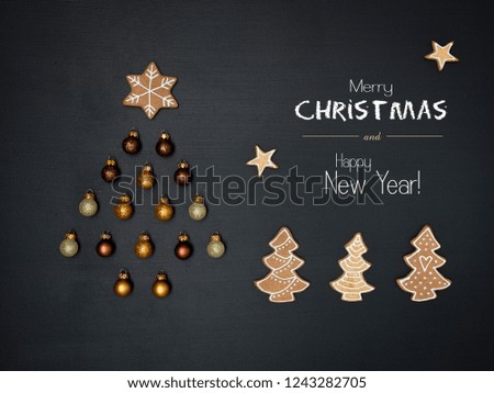 merry christmas lettering and christmas tree shaped out of different Christmas deco items, on black chalkboard