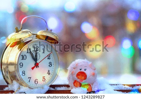 vintage alarm clock and the symbol of the year - a pig on a blurred background