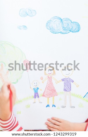 Cute child draws house and family on paper, top view