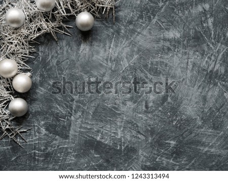 Christmas silver decoration with silver balls on grey background. Copyspace, Top View