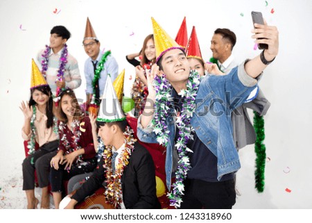 young asian man selfie or take a photo of Group happy  people having fun on the red sofa celebrating together in party on white background. friends . new year . funny