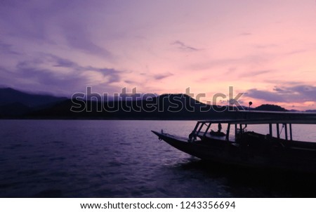 the boat on background after sunset at the dam 