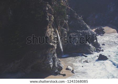 Beautiful aerial view of Mcway Falls with Julia Pfeiffer Beach and Pacific Ocean, Big Sur, Monterey County, California, United States
