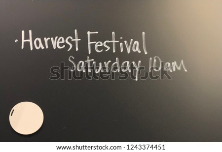 Blackboard promoting harvest festival Saturday 10am with blank space for copy