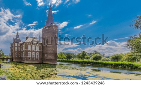 Hoensbroek castle surrounded by water on a wonderful sunny day with a blue sky and white clouds in south Limburg in the Netherlands Holland
