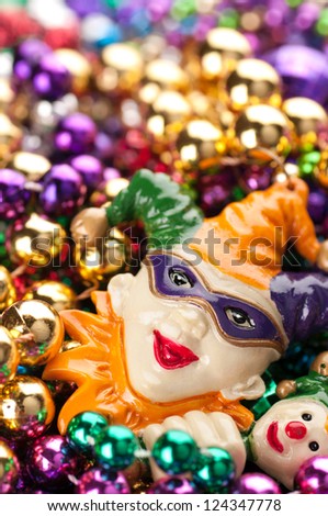 Vertical of Colorful, Plastic Mardi Gras Beads with Court Jester and Space for Copy or Text